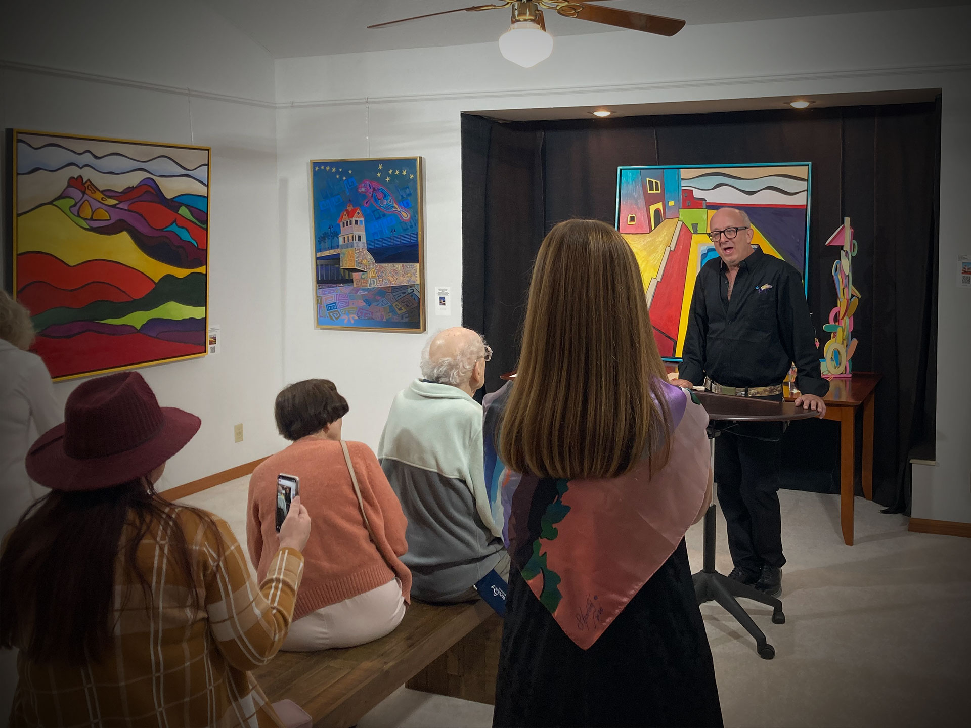 Stephen Shooster speaks during his art opening in the gallery.